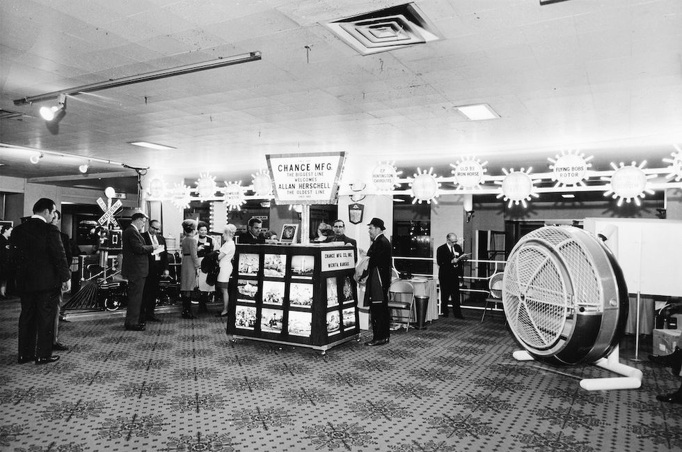 1960s trade show with Chance Mfg. booth and carnival ride displays.