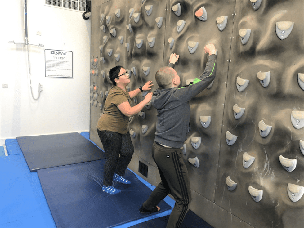 2 special needs children explore a climbing wall in Chamwell Centre