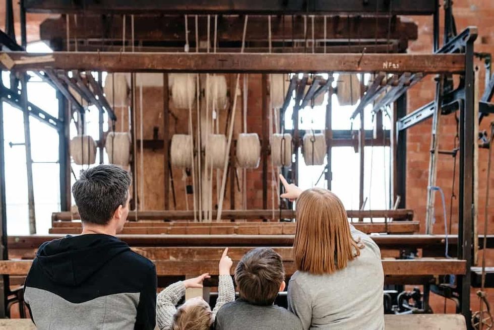 A family admire a loom at the Museum of Making