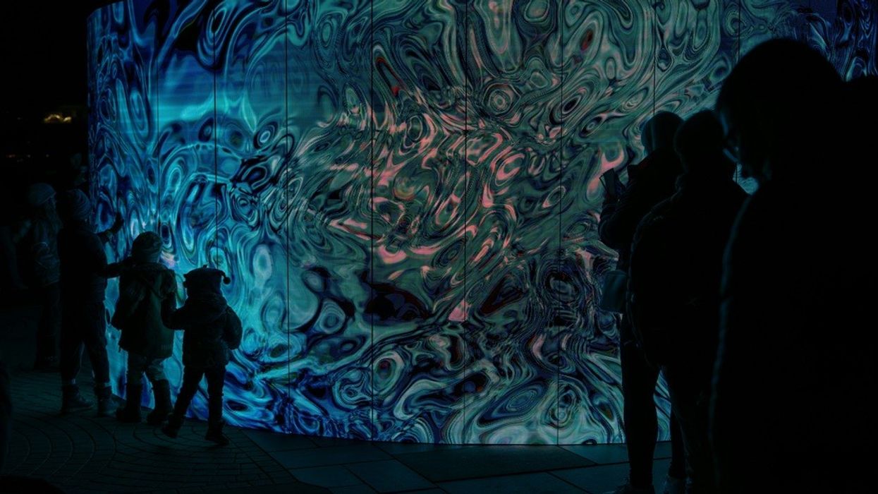 A group of people ion front of an LED wall