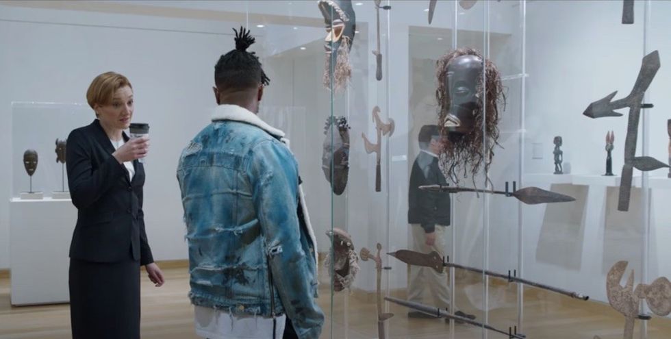 A screenshot of a scene from Black Panther where Killmonger prepares to steal back a looted Vibranium artifact made in Wakanda from the Museum of Great Britain. Museums in popular culture