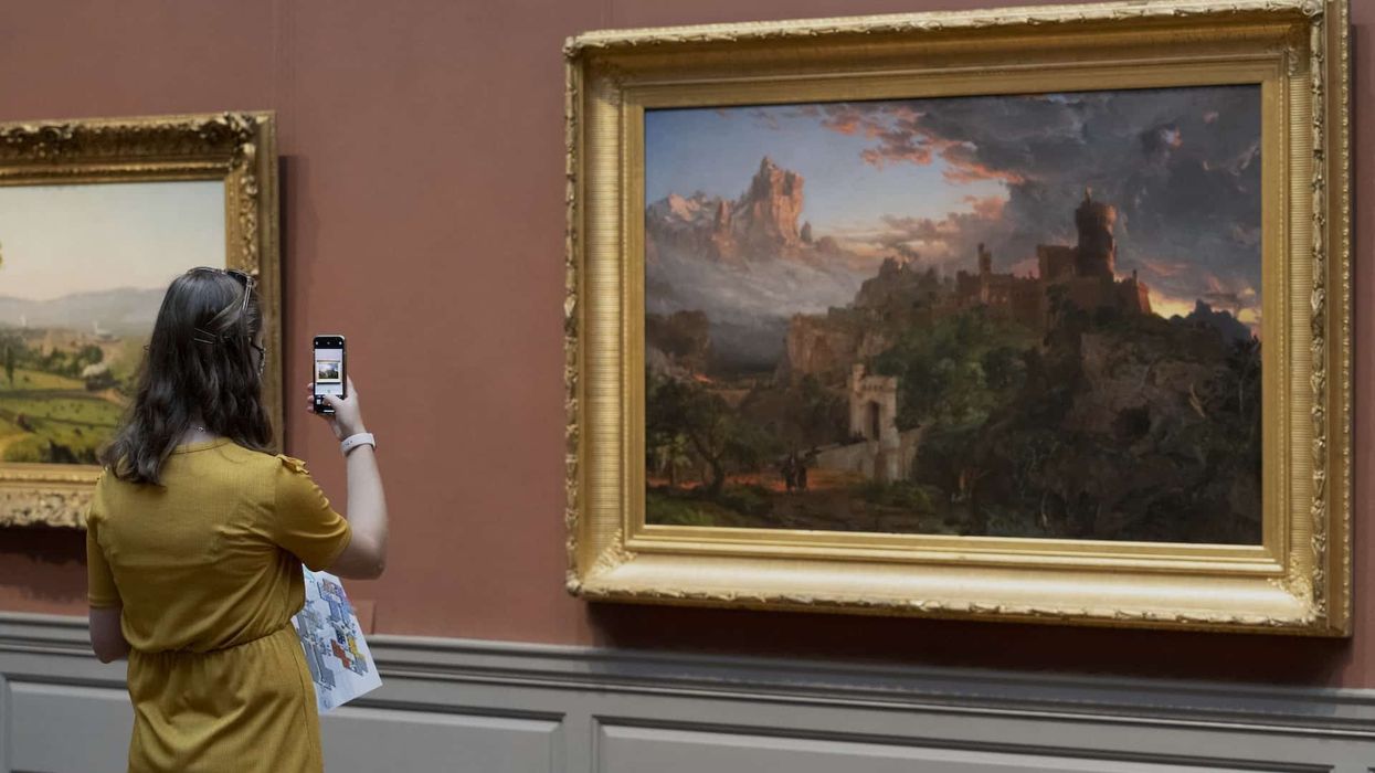 A visitor captures Jasper Francis Cropsey’s The Spirit of War, National Gallery of Art, Washington