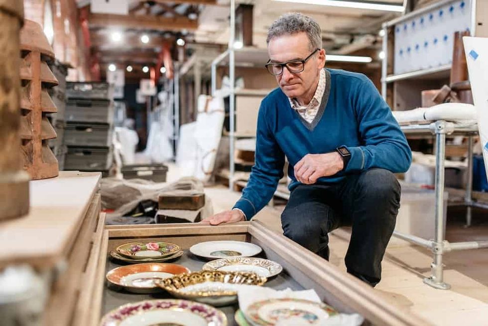 A visitor explores ceramics at the Museum of Making
