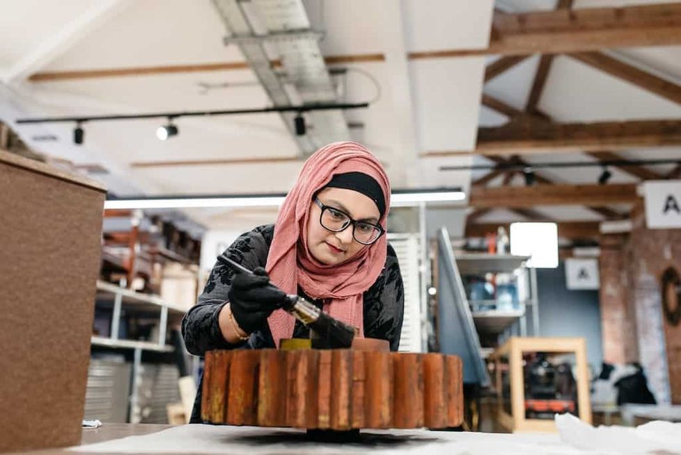 A volunteer helps to conserve objects behind scenes at the Museum of Making