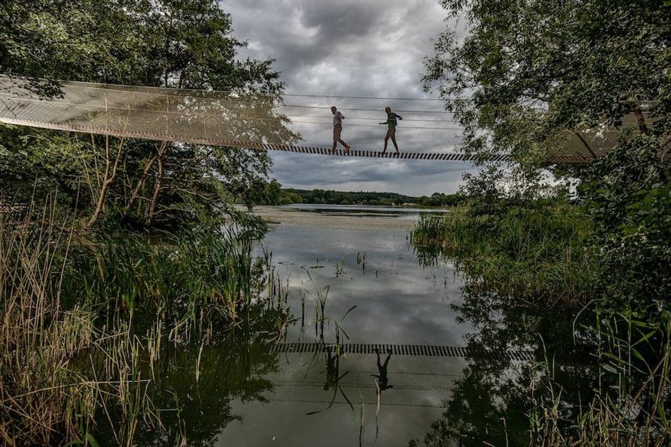 adults crossing the rope bridge to Skelf Island