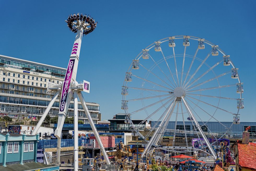 Adventure Island in Southend with a Ferris wheel and a tall spinning ride under a clear blue sky.