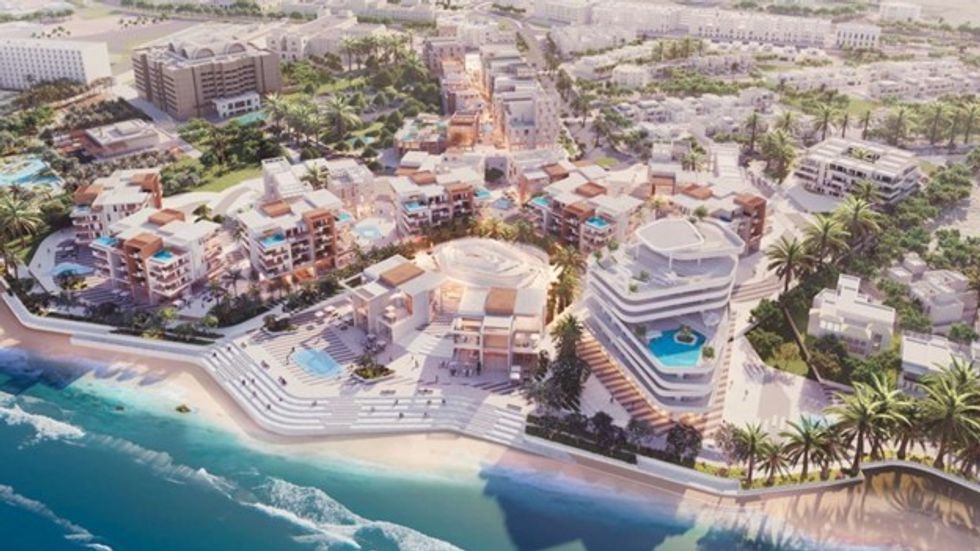 Aerial view of a beachside resort with pools, palm trees, and modern buildings.