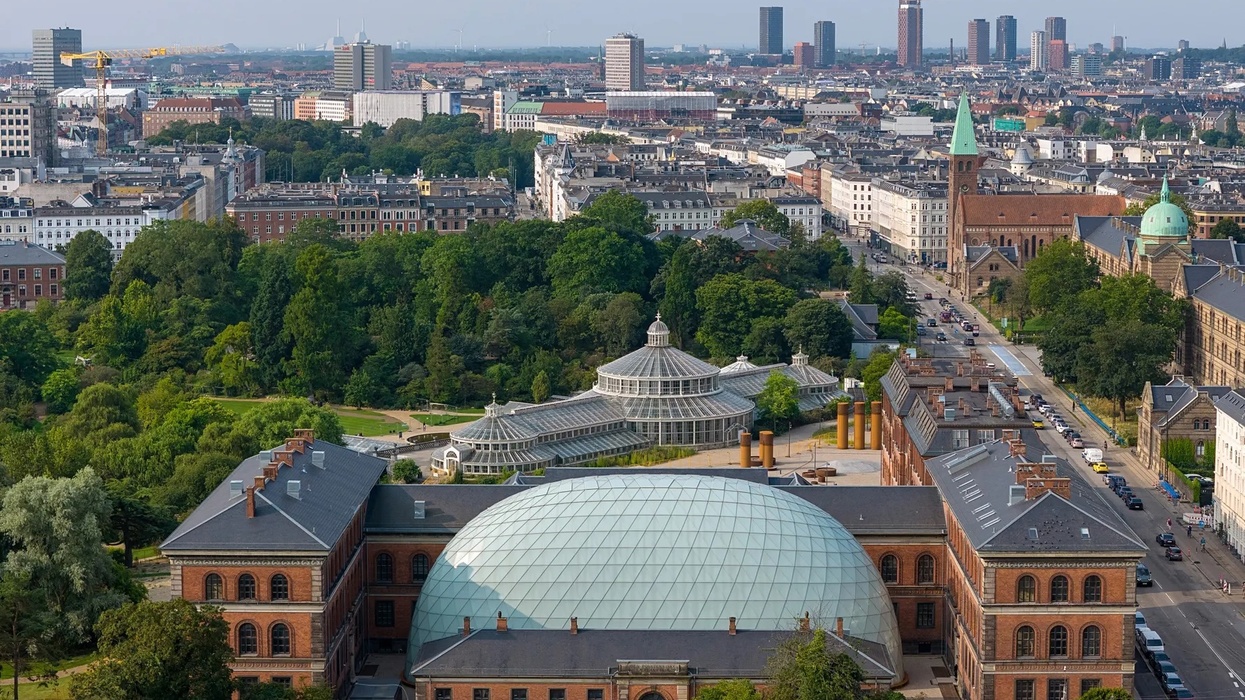 Aerial view of a cityscape with a botanical garden and glass conservatory at Denmark Natural History Museum