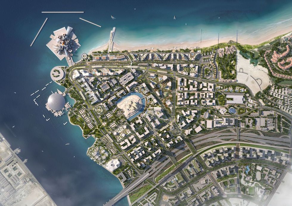 Aerial view of a coastal city layout with parks, roads, and circular structures by the sea.