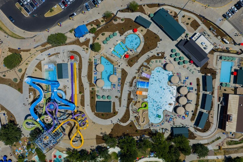 Aerial view of a colourful water park, Summit Canyon at Water World in Colorado, with pools and winding water slides.