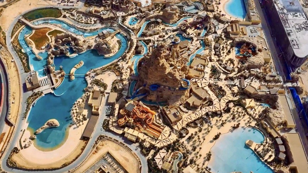 Aerial view of a desert-themed water park with pools, slides, and artificial rock formations.