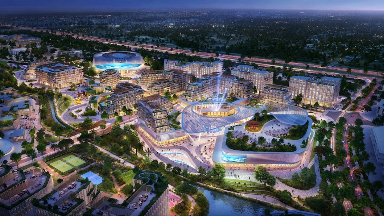 Aerial view of a modern, illuminated urban complex at night with surrounding greenery - masterplan for City Walk Abuja
