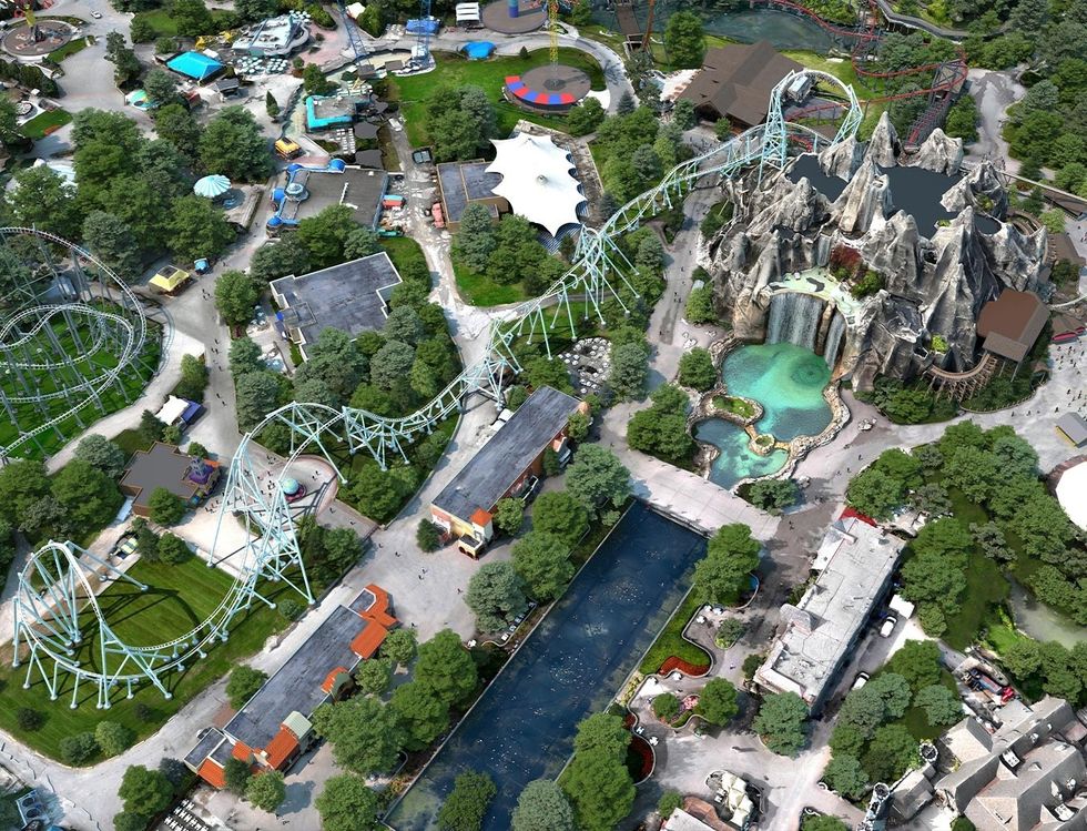 Aerial view of a theme park called Canada's Wonderland with roller coasters and rocky waterfall feature.