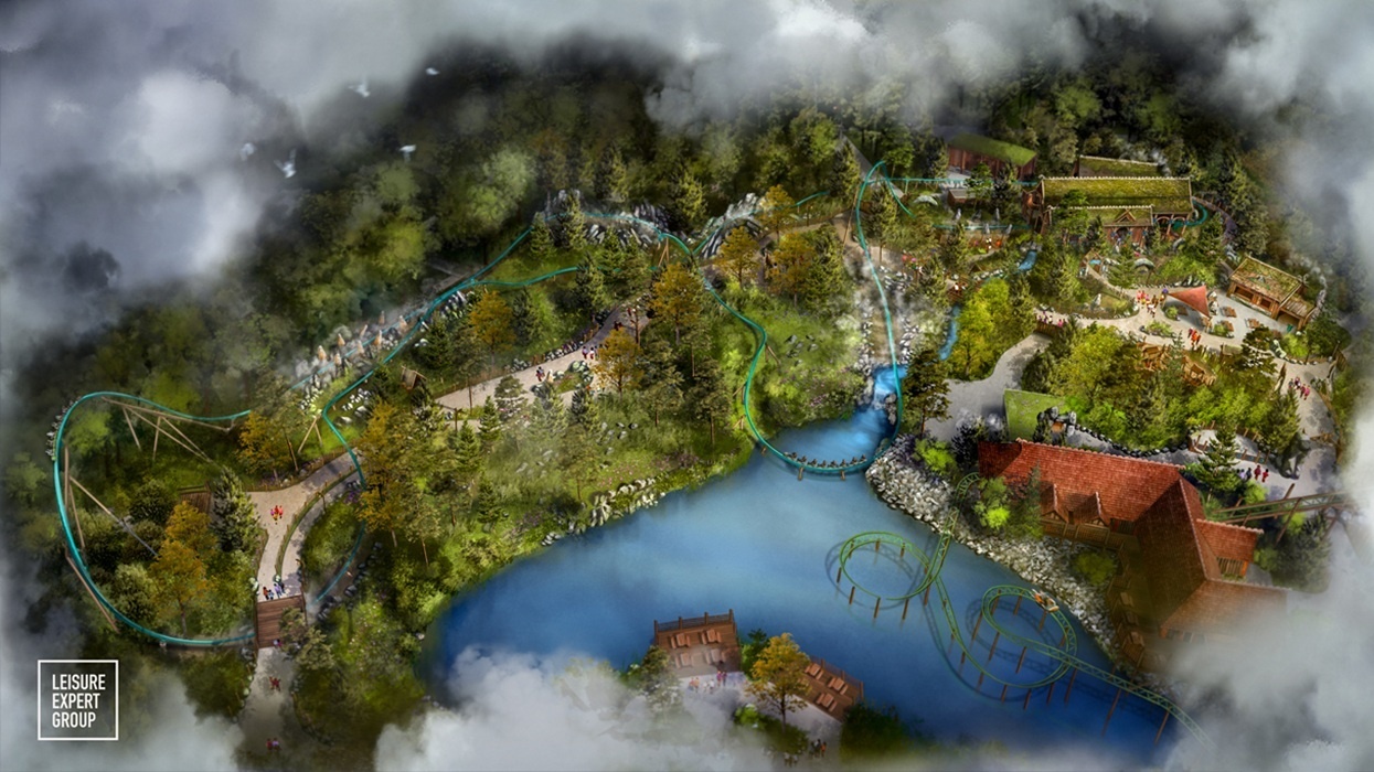 Aerial view of a theme park, Djurs Sommerland, with a winding roller coaster and lake.