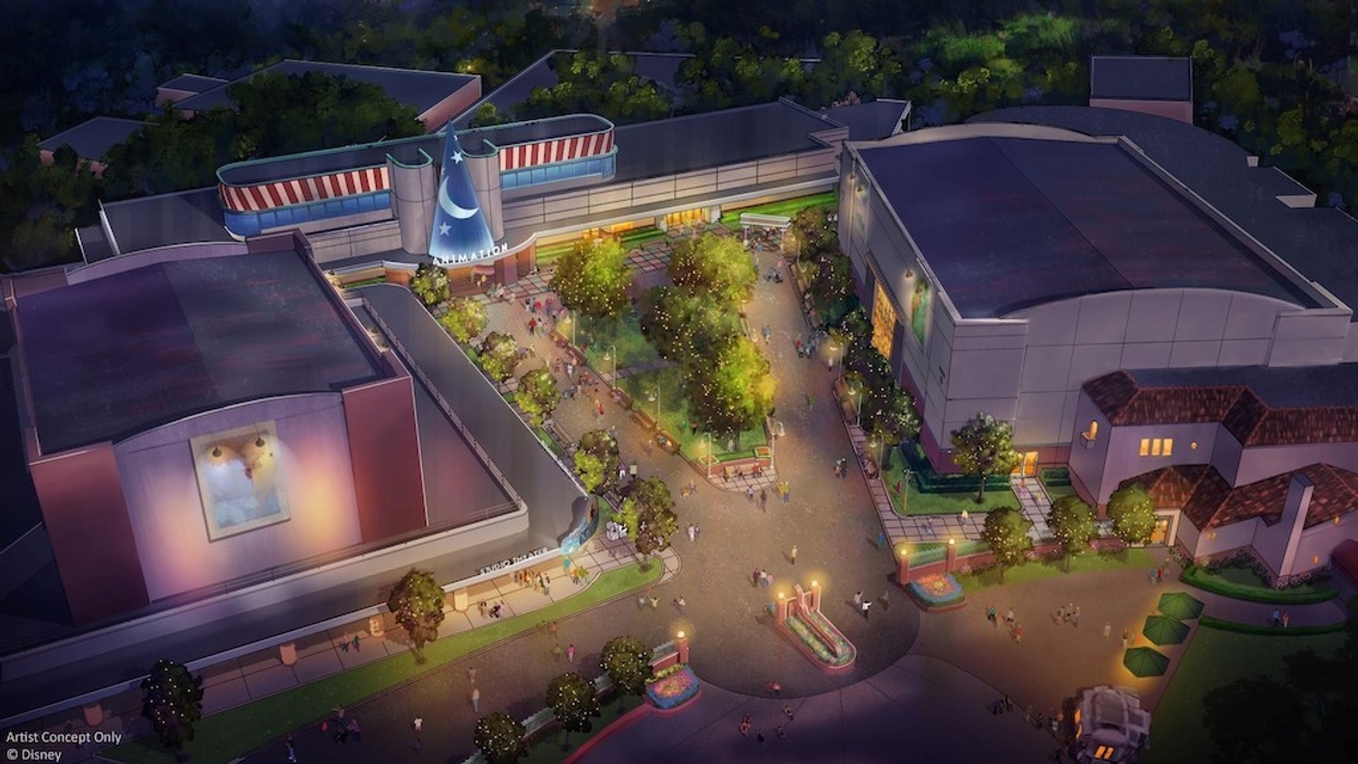 Aerial view of a themed animation studio with lit pathways and trees at night.
