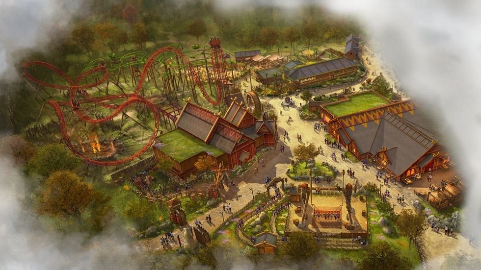Aerial view of a Viking-themed amusement park with roller coasters and Nordic buildings.