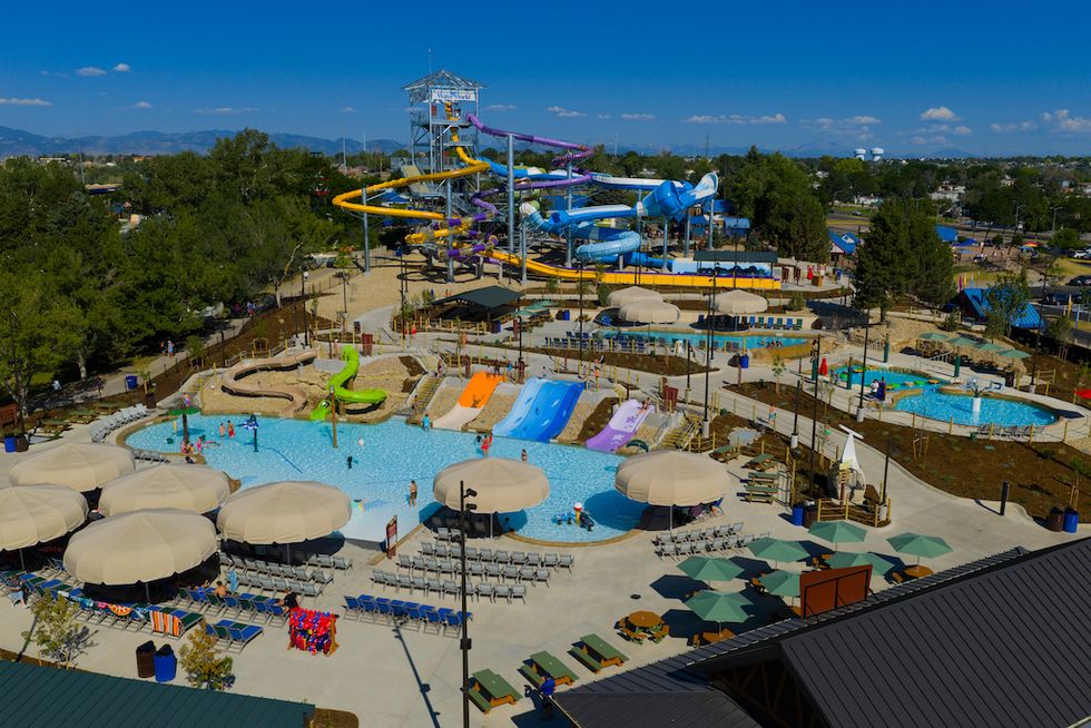 Aerial view of a water park with slides, pools, and umbrellas.