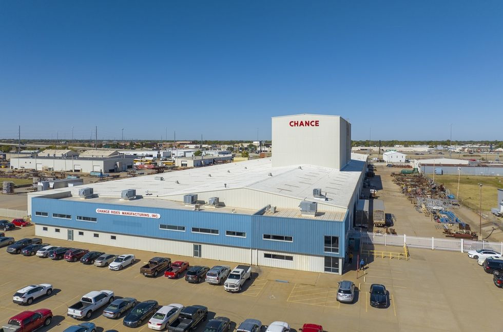 Aerial view of Chance Rides manufacturing facility, parking lot in foreground.