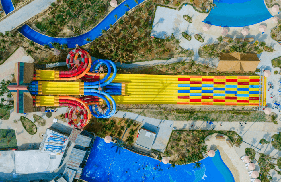 Aerial view of colorful water slides and pools in an amusement park.
