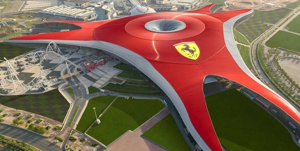 Aerial view of Ferrari World Abu Dhabi, a large red star-shaped building.
