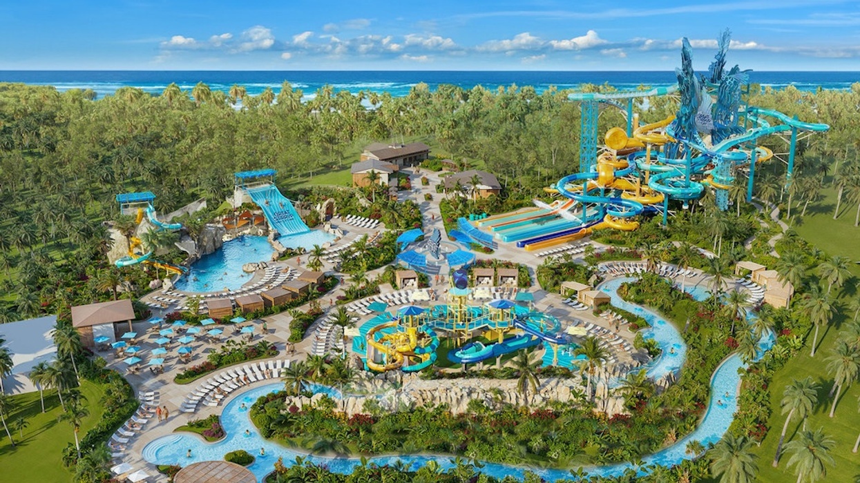 Aerial view of Great Tides Waterpark, a tropical water park with slides, pools, and lush greenery by the ocean, from Norwegian Cruise Lines