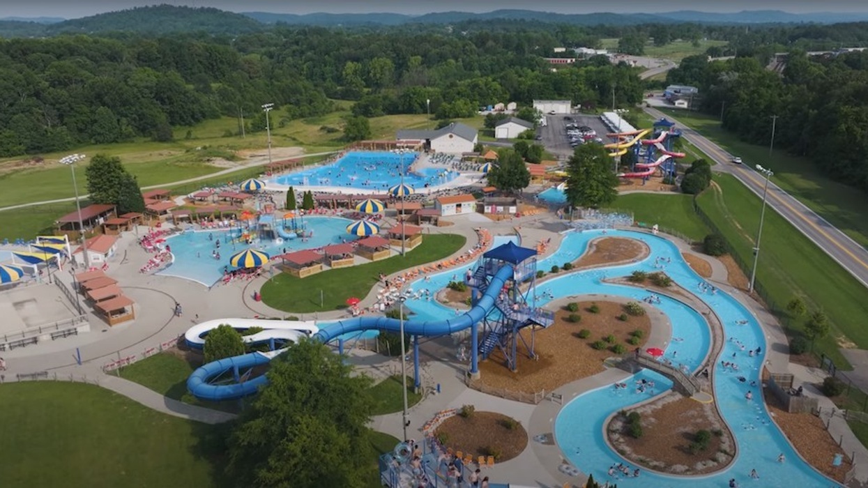 Aerial view of Somersplash water park with winding slides and pools, surrounded by green trees.