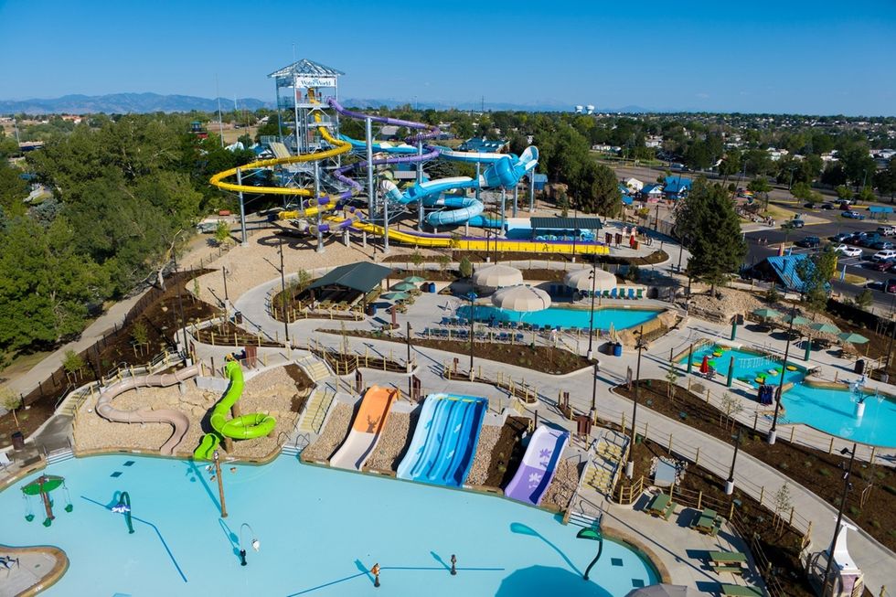 Aerial view of Summit Canyon at Water World in Colorado with winding slides and pools under a clear blue sky.