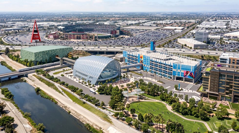 Aerial view of the OCVibe sports and entertainment district, with an arena, shops, parkland, and stadium.