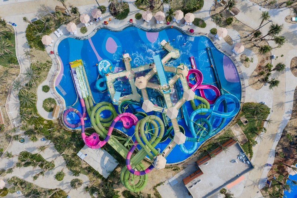 Aerial view of the RideHOUSE 600 Pro at Sun World V\u0169ng T\u00e0u Aqua Adventure, surrounded by trees and pathways.