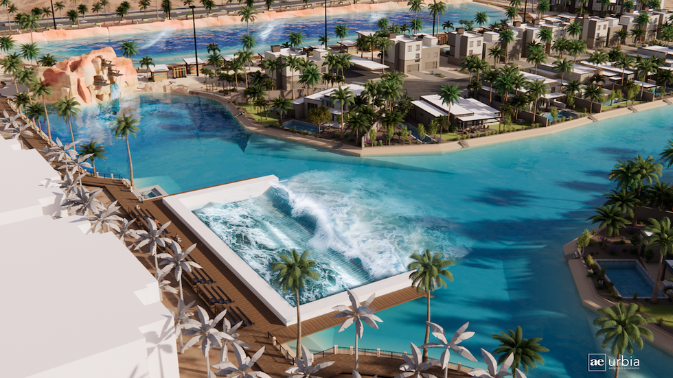 Aerial view of tropical resort with wave pool, palm trees, and villas.