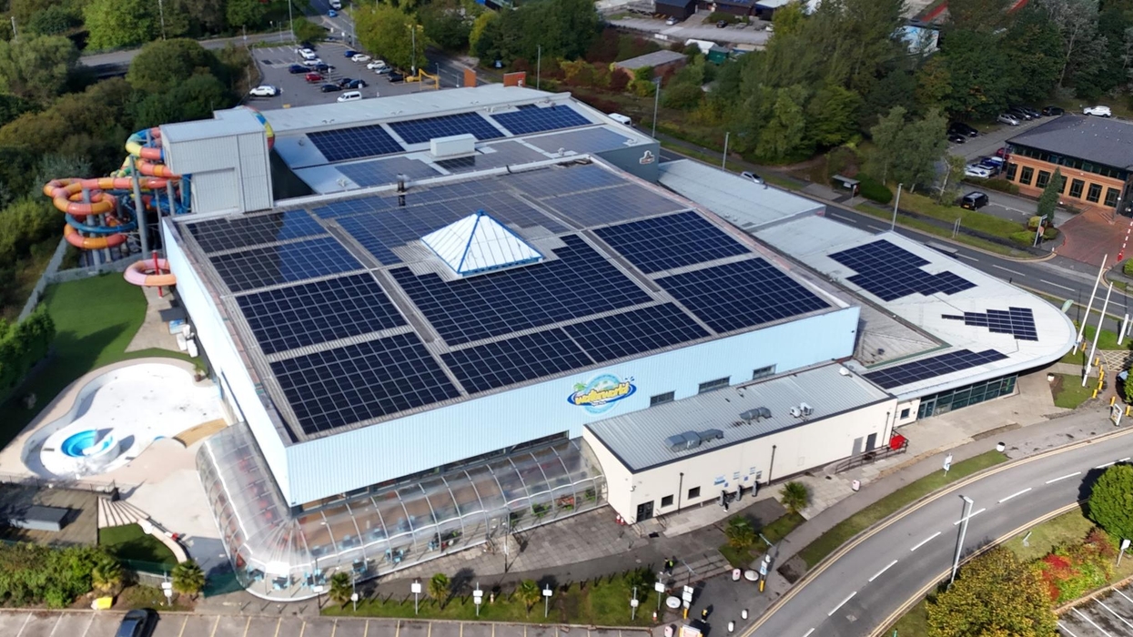 Aerial view of Waterworld Leisure Resort with solar panels and colorful water slides outside.