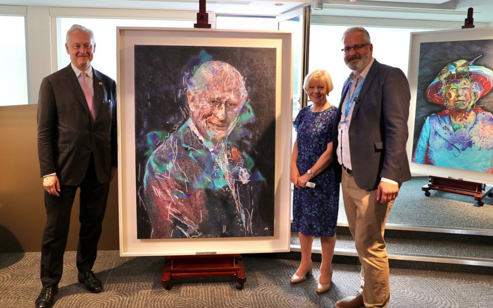 Ai-Da's portrait of King Charles III displayed on a large easel at AI for Good summit