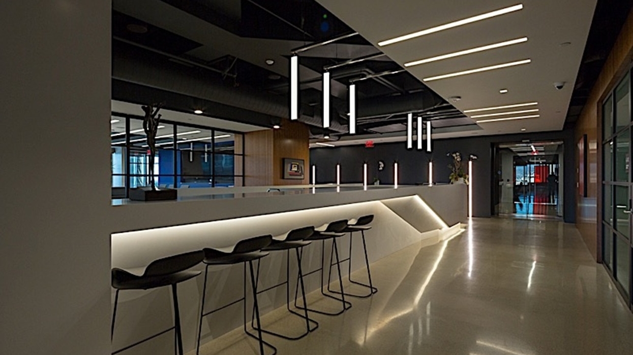 Akin Gump Law Offices modern lobby with bar stools, sleek lighting, and glossy floors.