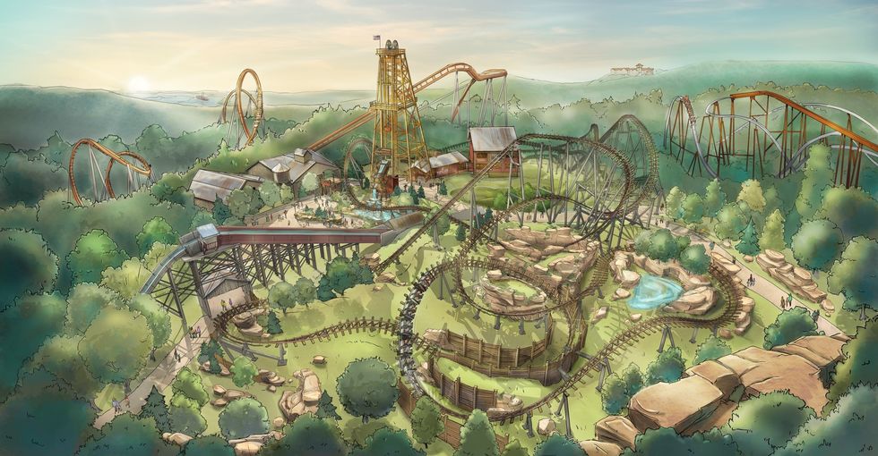 Amusement park called Silver Dollar City with roller coasters winding through a forested landscape at sunset.