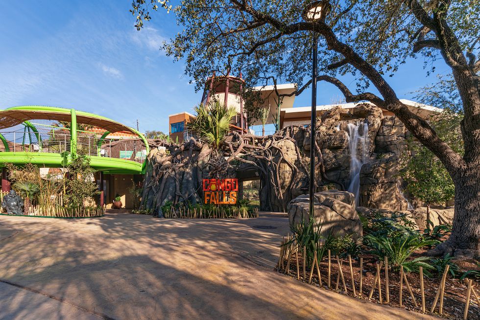 Amusement park entrance with "Congo Falls" sign, surrounded by trees and a waterfall.
