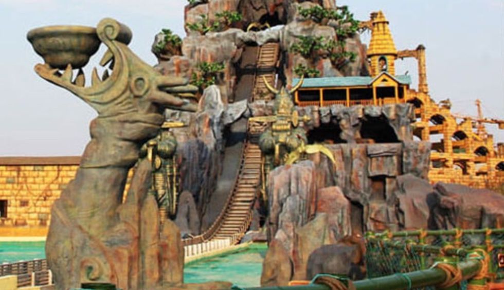 Amusement park ride with a stylized stone dragon and water slide at fantawild adventure shenyang