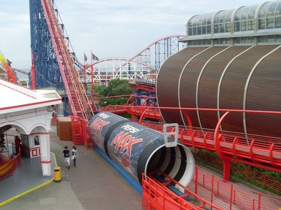 Amusement park ride with Pepsi Max-themed roller coaster and red tracks.
