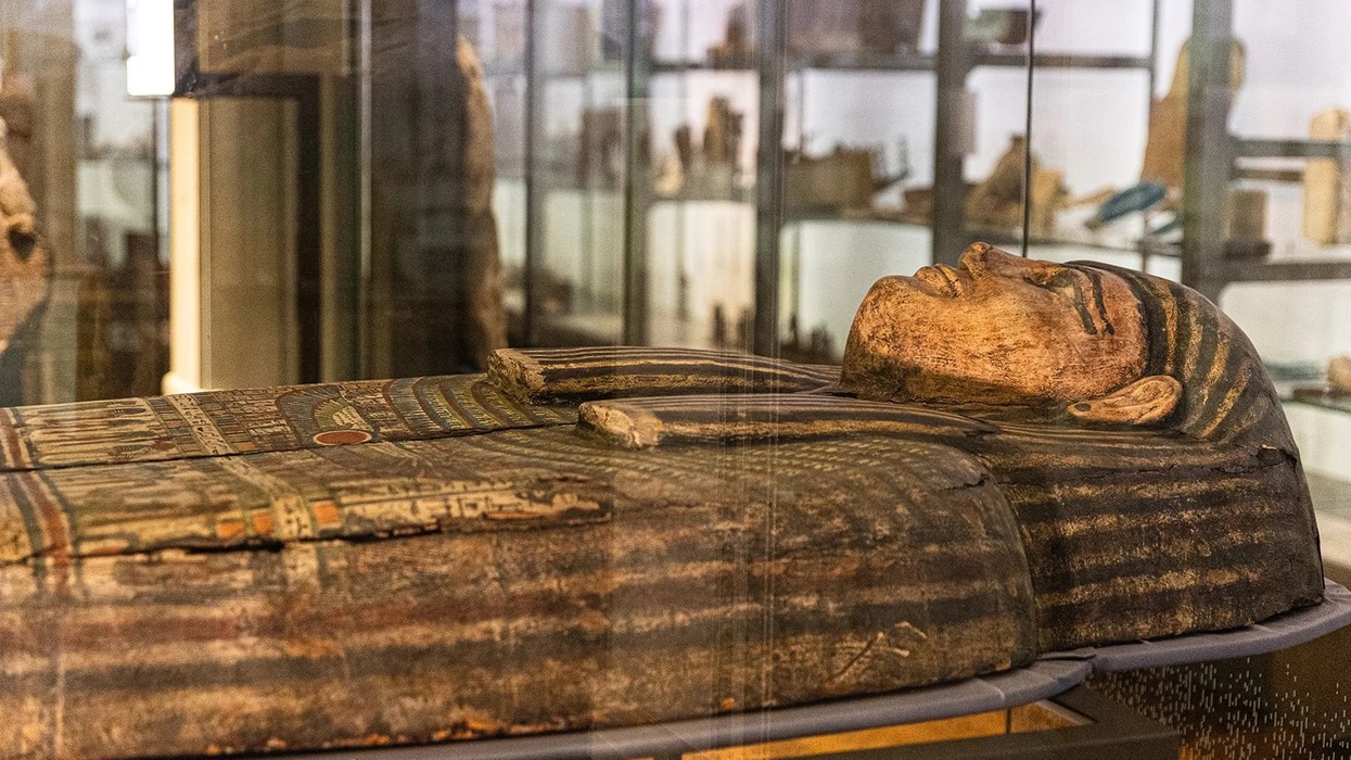 Ancient Egyptian sarcophagus displayed in a museum exhibit at Manchester Museum