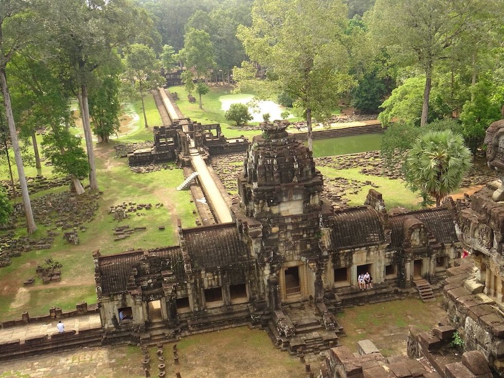 Ancient temple ruins surrounded by lush greenery and stone pathways.