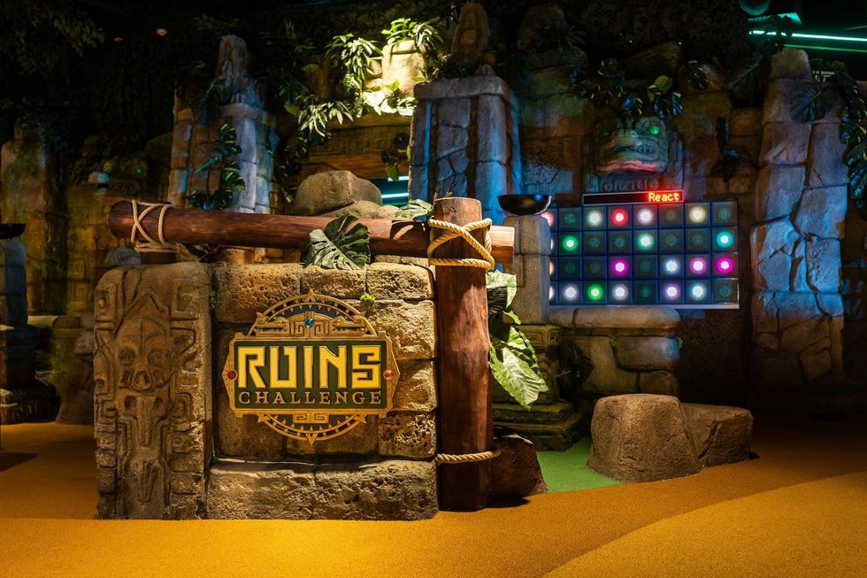 Ancient-themed "Ruins Challenge" area with lights and stone structures.