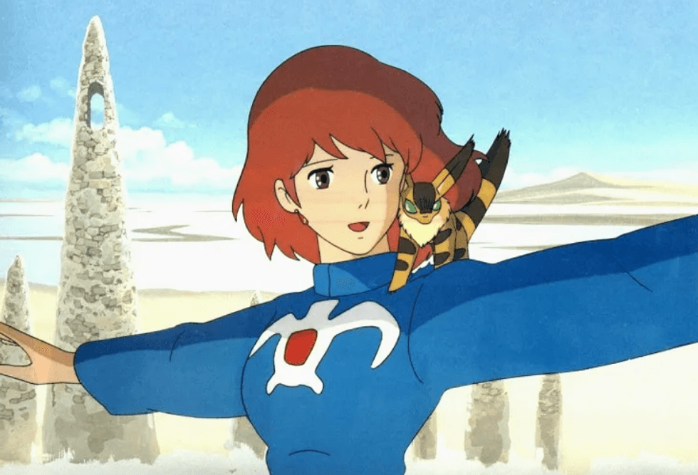 Anime character with red hair and pet on shoulder, standing in a rocky desert landscape.