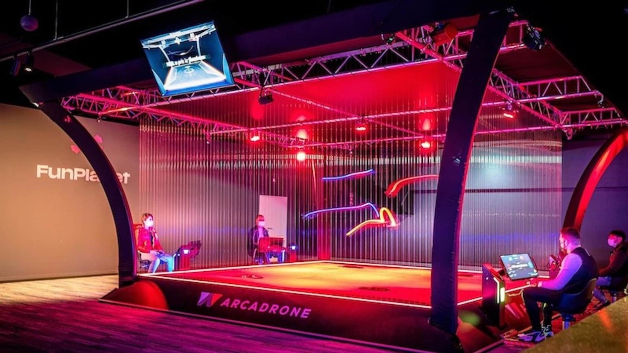 arcadrone drones flying lights blurry people playing