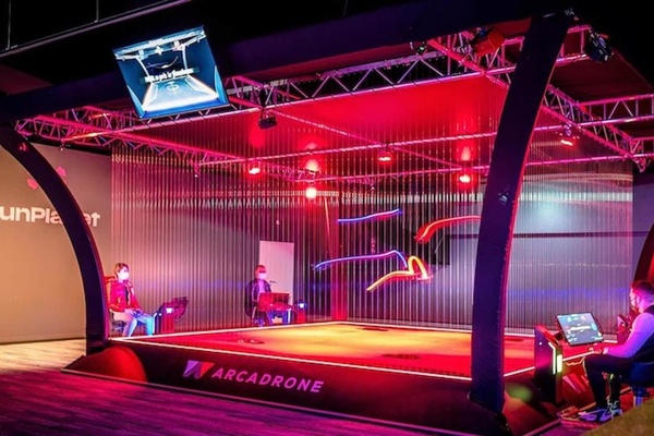 arcadrone drones flying lights blurry people playing