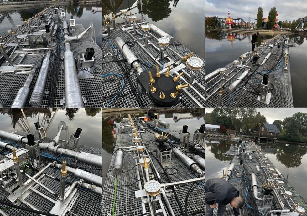 Array of metal pipes and valves on a floating platform over water.