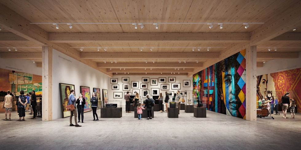 Art gallery at the Bruce Springsteen Center for American Music with diverse artworks on walls and visitors viewing exhibits.