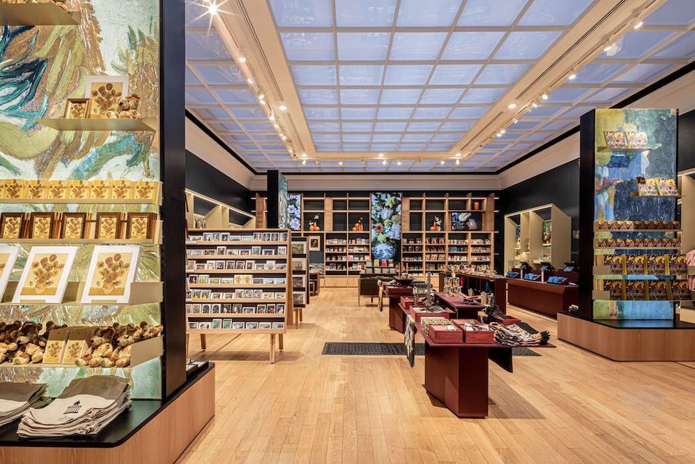 Art-themed store interior with vibrant displays and wooden shelves under a grid ceiling.