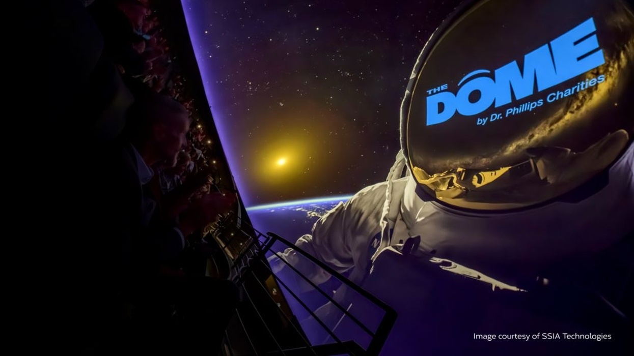 Astronaut projected on a theater dome screen at Orlando Science Center, with Earth and space backdrop.