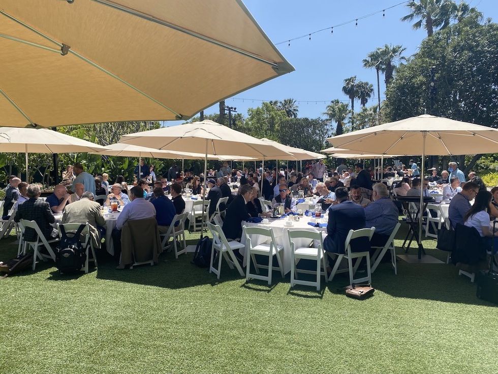 Attendees eating lunch on the disneyland lawn at TEA Summit 2022
