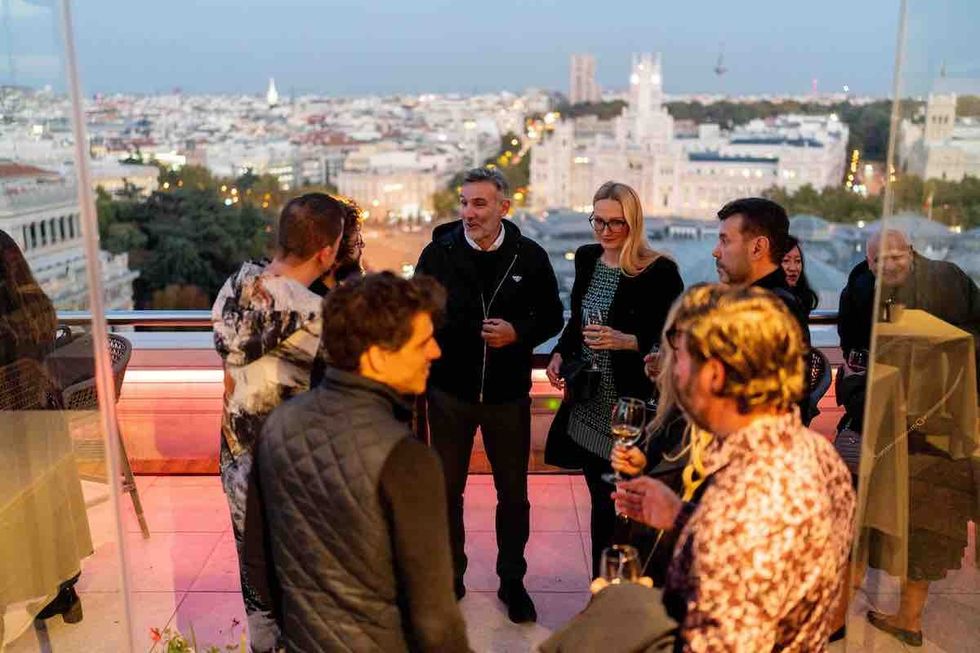 attendees talk at the GXG event on rooftop