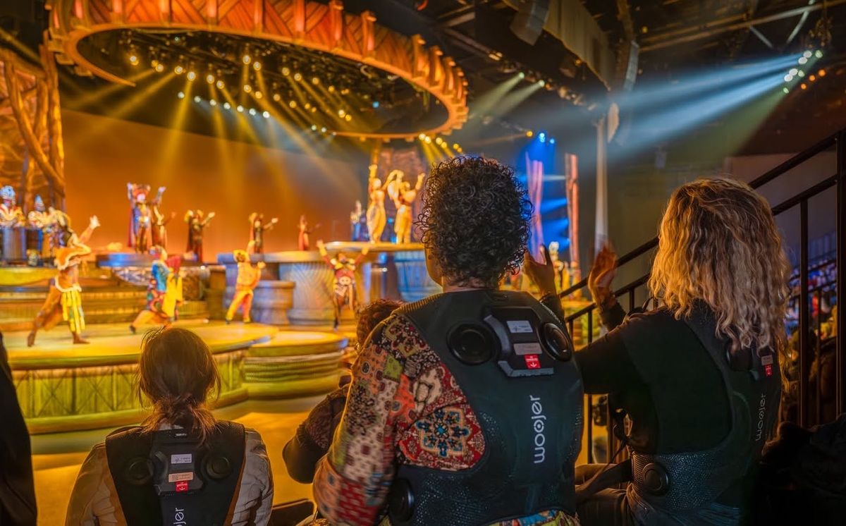 ​Audience members wearing vests that turn sound into vibrations during The Lion King: Rhythms of the Pride Lands at Disneyland Paris